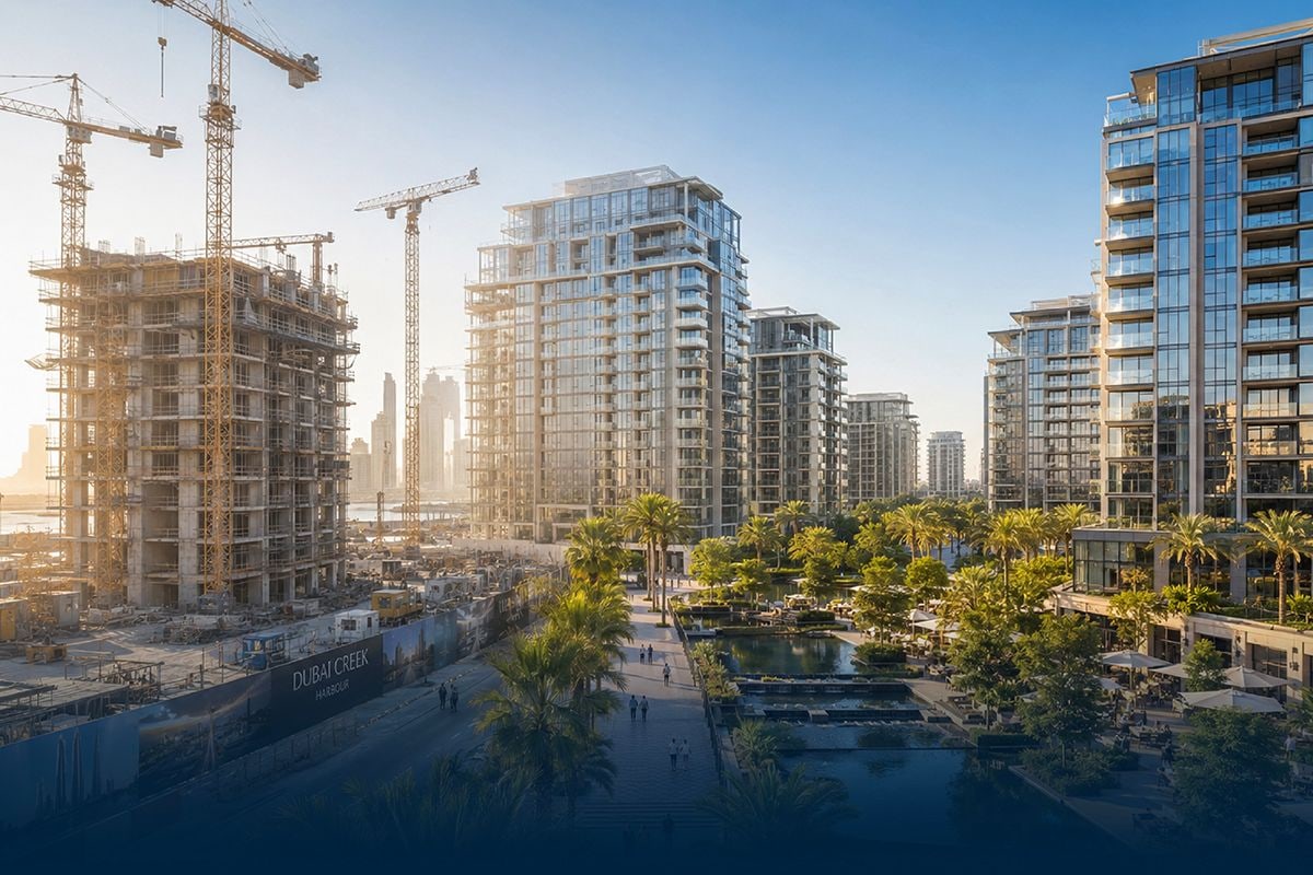 Off-plan construction cranes beside a completed residential development in Dubai