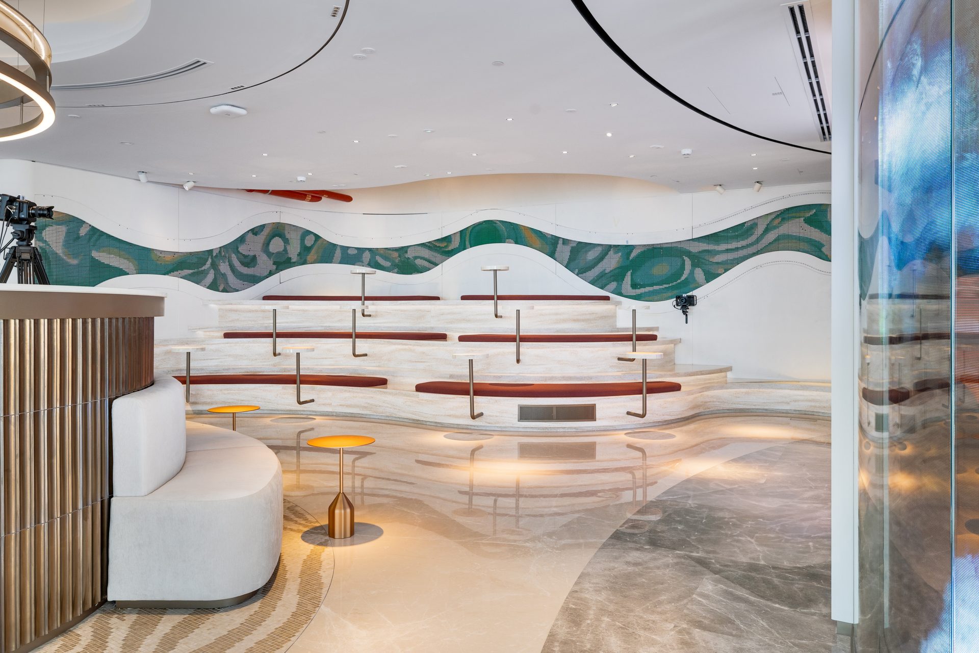 Tiered amphitheater seating with mosaic wave mural