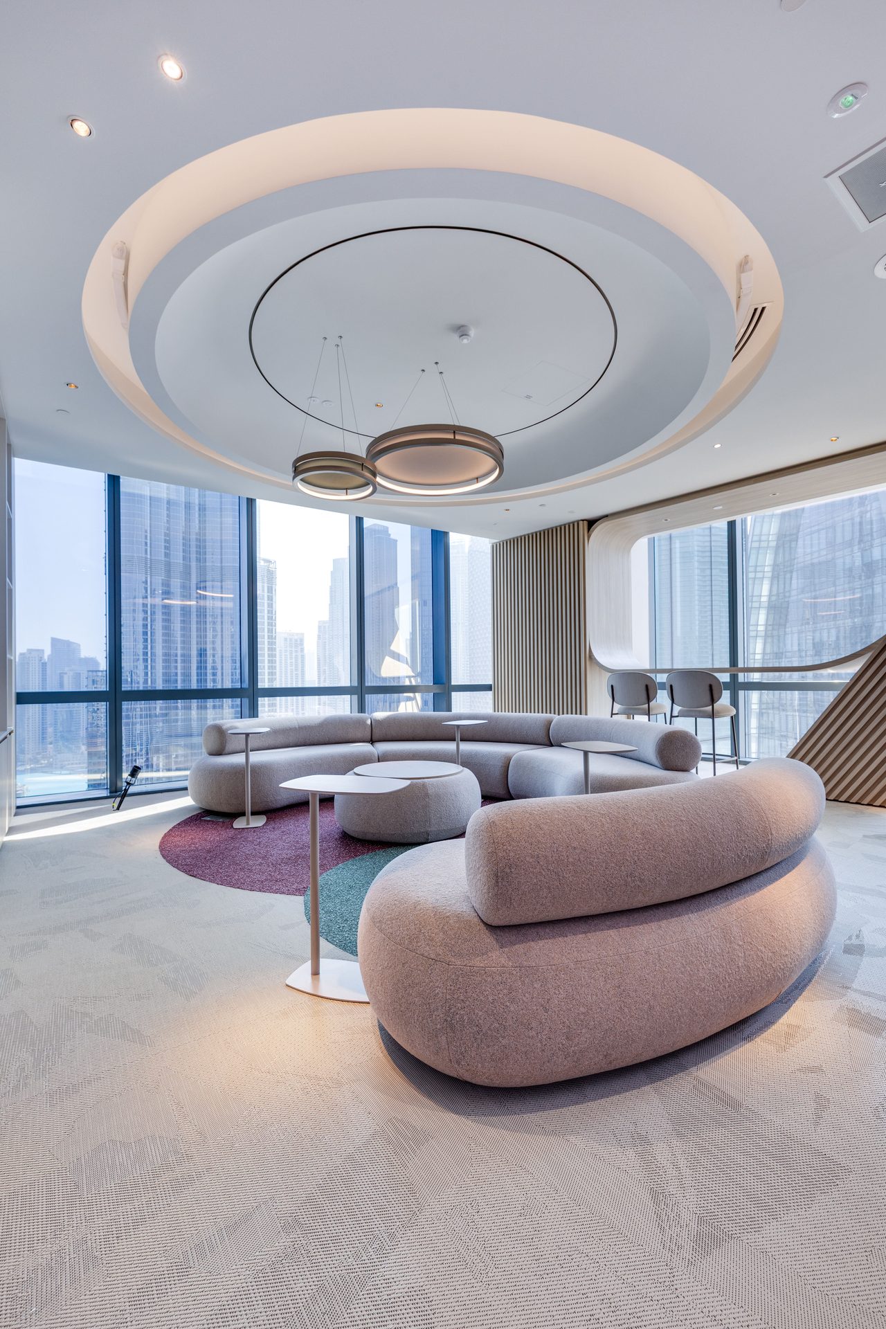 Curved lounge seating with round drop ceiling
