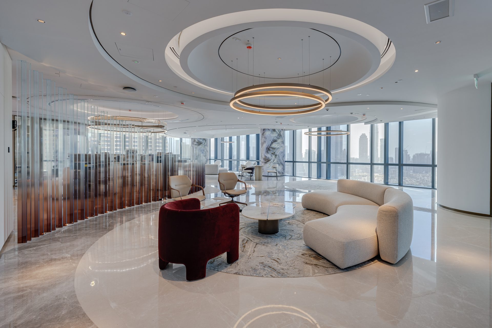 Reception waiting area with velvet armchair and glass fin partition